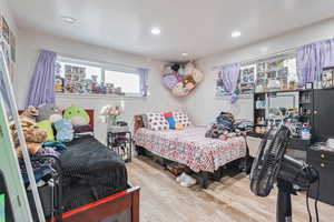 Bedroom featuring light wood-type flooring and recessed lighting