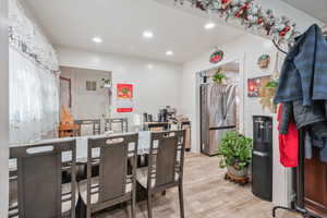 Kitchen featuring visible vents, recessed lighting, freestanding refrigerator, and light wood-style floors