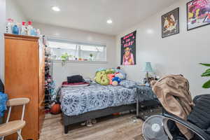 Bedroom featuring light wood-type flooring and recessed lighting