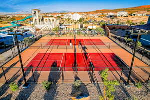 View of sport court featuring a residential view, fence, and a mountain view