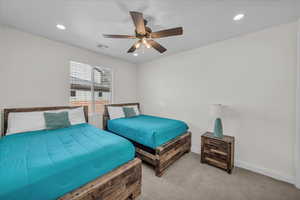 Bedroom with recessed lighting, visible vents, a ceiling fan, light carpet, and baseboards