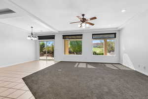 Spare room with light tile patterned floors, a chandelier, ceiling fan, and beam ceiling