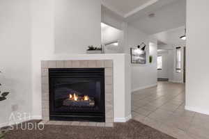 Detailed view of a fireplace, a smoke detector, and baseboards