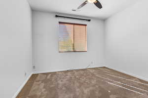 Empty room with carpet flooring and ceiling fan