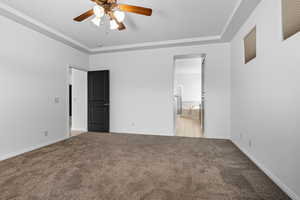 Unfurnished bedroom with light colored carpet, a ceiling fan, and ensuite bath