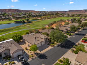 Aerial view of residential area with a golf club and a water and mountain view