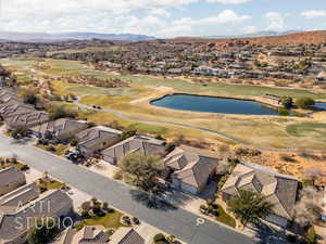 Aerial perspective of suburban area with a water and mountain view and a golf club