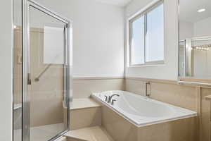 Full bath with a shower stall and a garden tub