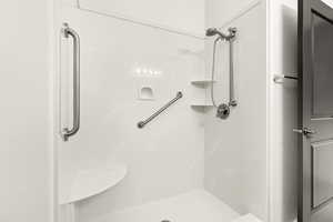 Full bathroom featuring a shower stall