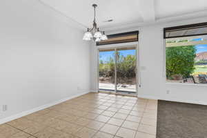 Unfurnished dining area with light tile patterned floors and a chandelier