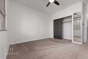 Unfurnished bedroom featuring carpet flooring, baseboards, a closet, and a ceiling fan