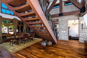 Dining space featuring hardwood / wood-style flooring and a high ceiling