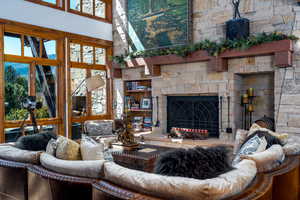 Living room featuring a high ceiling and a fireplace