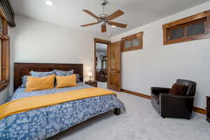 Bedroom featuring light carpet and ceiling fan