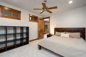 Bedroom featuring ceiling fan and light colored carpet