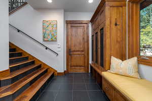 Mudroom with dark tile patterned floors