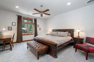 Carpeted bedroom with ceiling fan