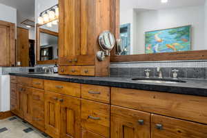 Bathroom with tasteful backsplash and vanity