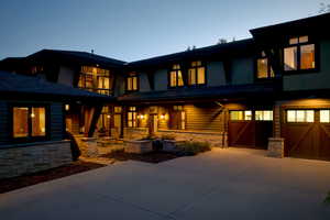 Back house at dusk with a garage