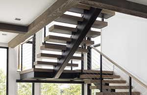 Stairway featuring beam ceiling and visible vents