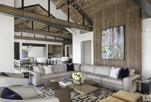 Living room with wooden ceiling, an inviting chandelier, and vaulted ceiling with beams