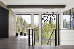 Entryway featuring dark wood-style floors and beamed ceiling