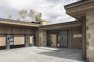 View of exterior entry featuring stone siding