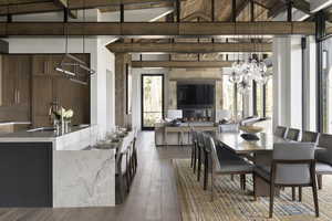 Dining area with a glass covered fireplace and wood finished floors