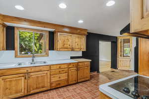 Kitchen featuring light countertops, a sink, and recessed lighting
