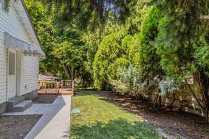 View of yard featuring entry steps and a deck