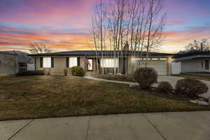 View of front of home featuring a front lawn, brick siding and new roof