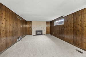 Family Room with new carpet, a fireplace, v