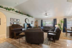 Living area featuring a wealth of natural light, lofted ceiling, and light wood finished floors