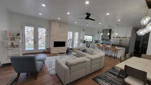 Living room featuring dark hardwood / wood-style floors, a wealth of natural light, and french doors