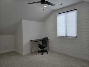 Bedroom with light carpet, visible vents, vaulted ceiling, and a textured ceiling, ceiling fan and closet