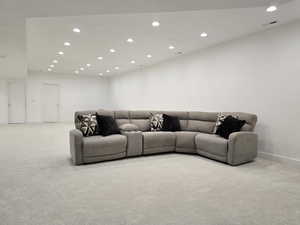 A finished basement is great for another family room or game room featuring baseboards, carpet floors, and recessed lighting