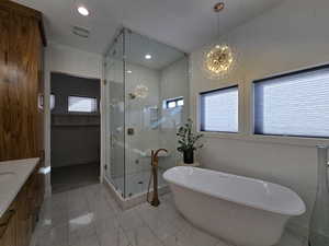 Bathroom with a freestanding tub, recessed lighting, vanity, marble finish floor, and a steam shower