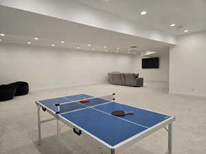 A finished basement is great for another family room or game room featuring baseboards, carpet floors, and recessed lighting