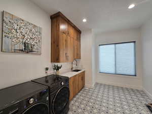 Laundry room with recessed lighting, cabinet space, a sink, independent washer and dryer, baseboards, and a beautiful tiled floor