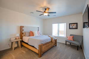 Bedroom with carpet flooring, visible vents, and baseboards