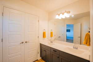 Full bath featuring a sink and double vanity