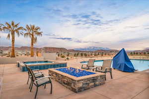 Pool featuring an outdoor fire pit, a jacuzzi, and a mountain view