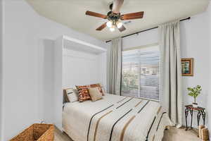 Bedroom featuring carpet flooring, visible vents, and a ceiling fan