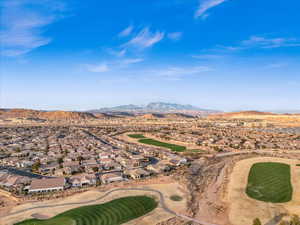 Property view of mountains with golf course view and a residential view