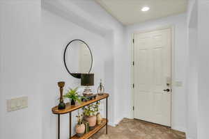 Entryway with baseboards and recessed lighting