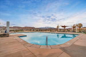 Pool featuring a patio area and a mountain view