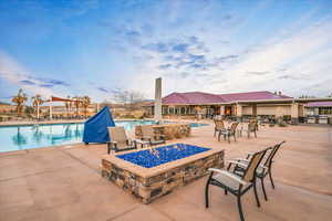 Pool featuring a patio area and a fire pit