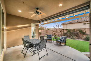 View of patio featuring a fenced backyard, ceiling fan, a pergola, and outdoor dining space