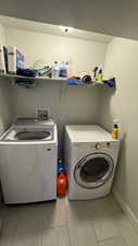 Washroom featuring washing machine and dryer