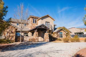 View of front of house featuring stone siding and stucco siding